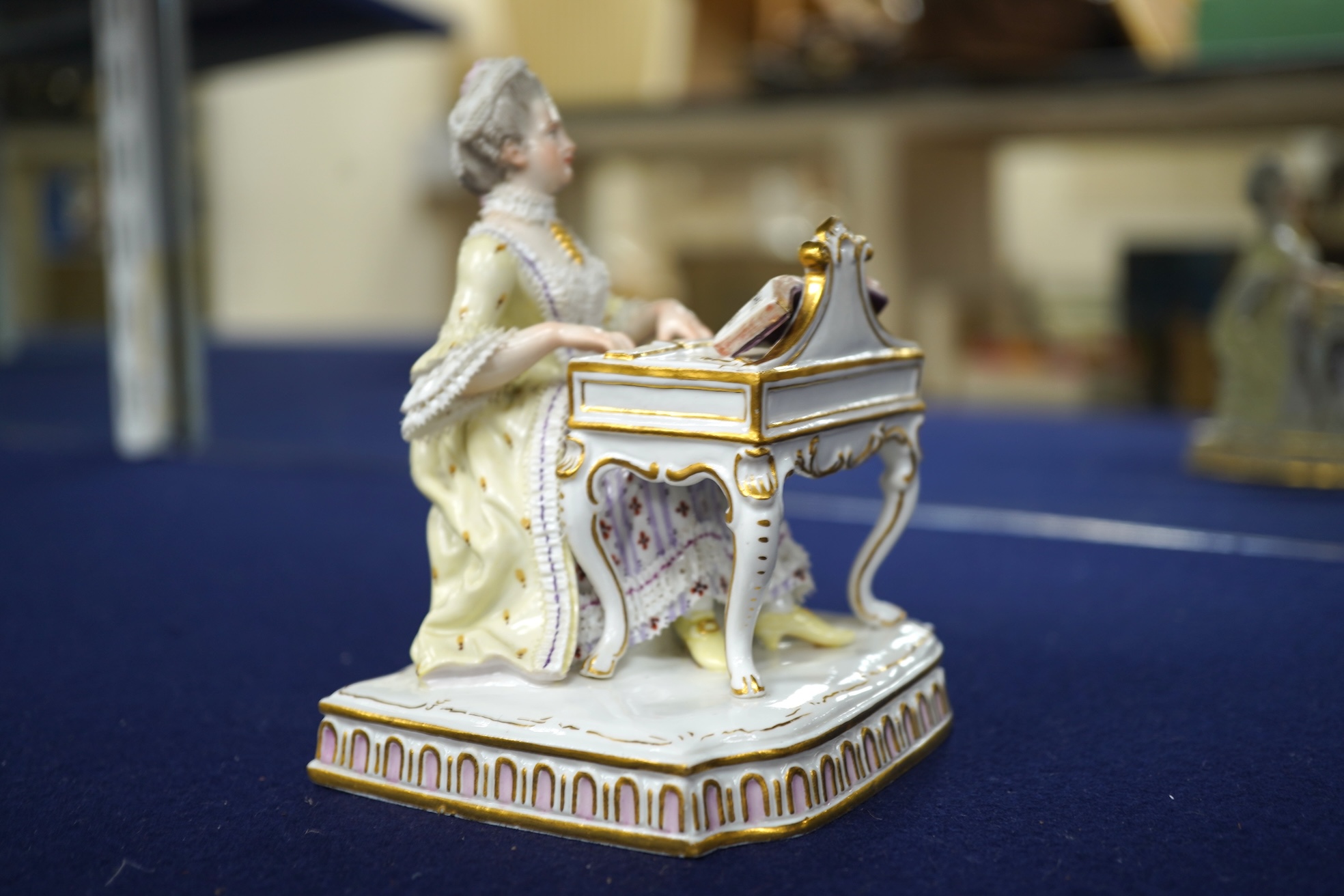 A pair of 19th century Meissen figures of a girl holding a shell and a boy holding a book, in size model number 628, tallest 13cm